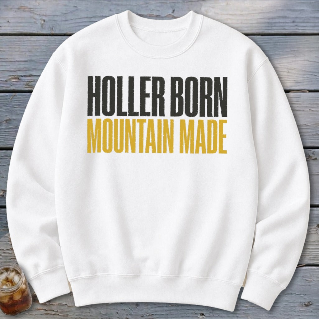 White sweatshirt with black and gold text reading "Holler Born Mountain Made."