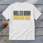White t-shirt with black and gold text reading "Holler Born Mountain Made."