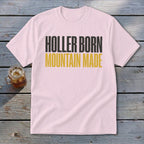 Pink t-shirt with "Holler Born Mountain Made" text in black and gold.