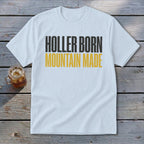 White t-shirt with "Holler Born Mountain Made" text in black and yellow.