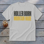 White t-shirt with "HOLLER BORN MOUNTAIN MADE" text.