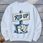 Light blue sweatshirt with a graphic of a wooden sign reading "RID UP" above a bucket.