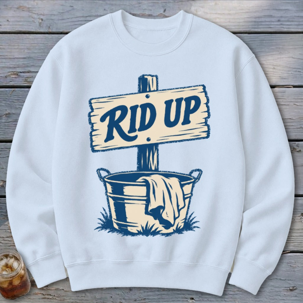 Light blue sweatshirt with a graphic of a wooden sign reading "RID UP" above a bucket.
