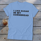 Light blue t-shirt with black text reading "I LIKE SUGAR IN MY CORNBREAD".