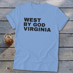 Light blue t-shirt with "WEST BY GOD VIRGINIA" in black text.