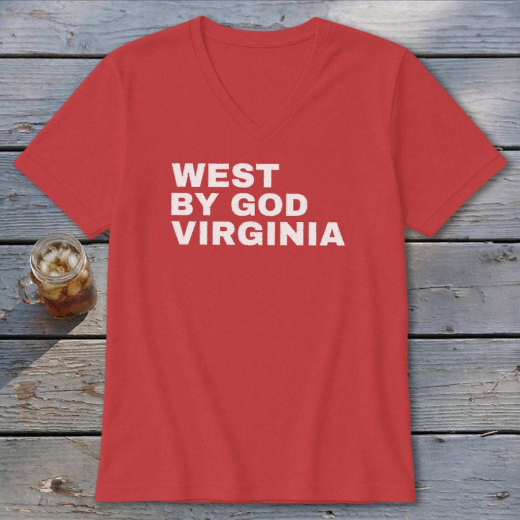 Red v-neck t-shirt with white "WEST BY GOD VIRGINIA" text and a drink on a wooden table.