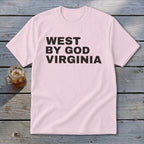 Pink t-shirt with "WEST BY GOD VIRGINIA" printed in black text.