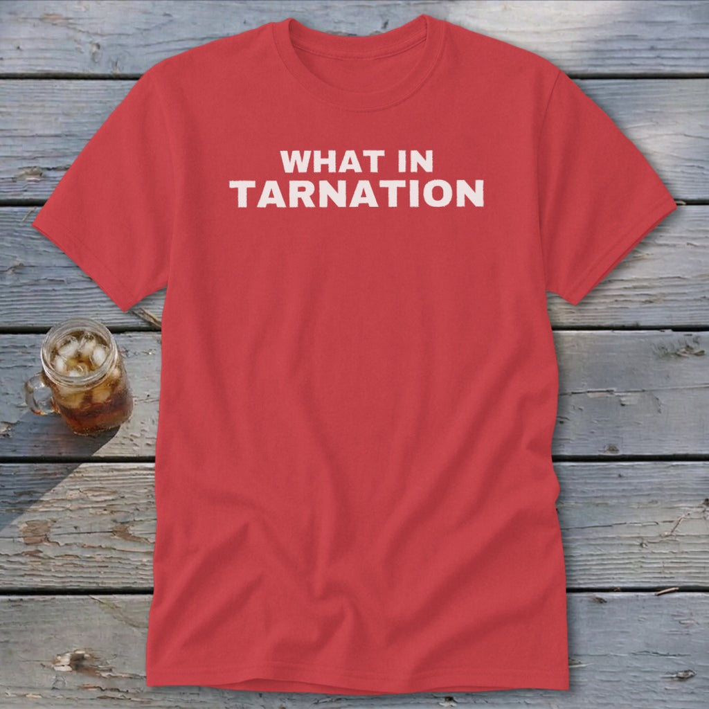 Coral t-shirt with white text reading "WHAT IN TARNATION" and a glass of iced tea.