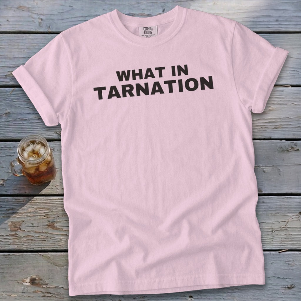 Light pink t-shirt with black text reading "WHAT IN TARNATION."