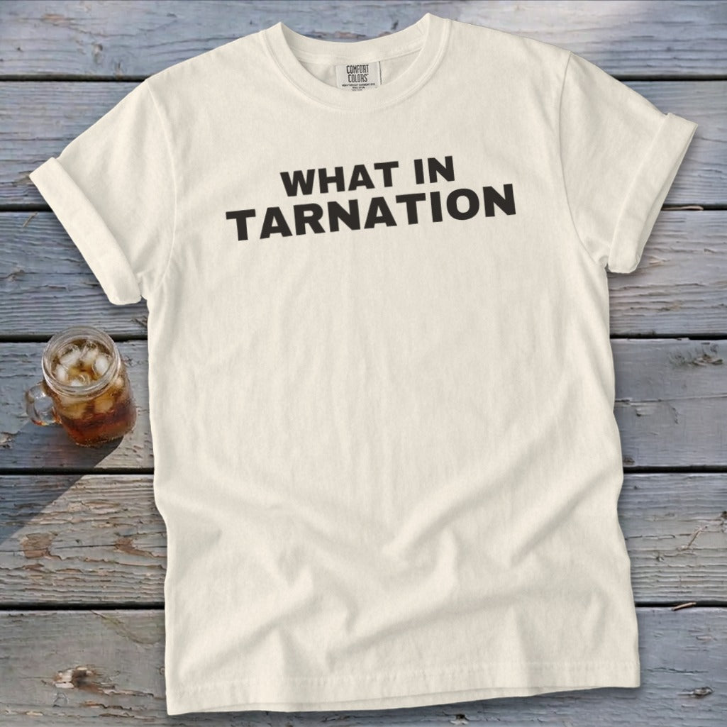 Cream t-shirt with black text reading "WHAT IN TARNATION" and a glass of iced tea.