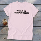 Light pink t-shirt with "WHAT IN TARNATION" printed in black text.