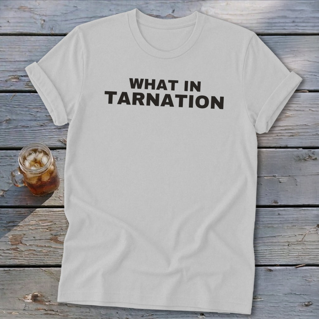 White t-shirt with "WHAT IN TARNATION" printed in black text.