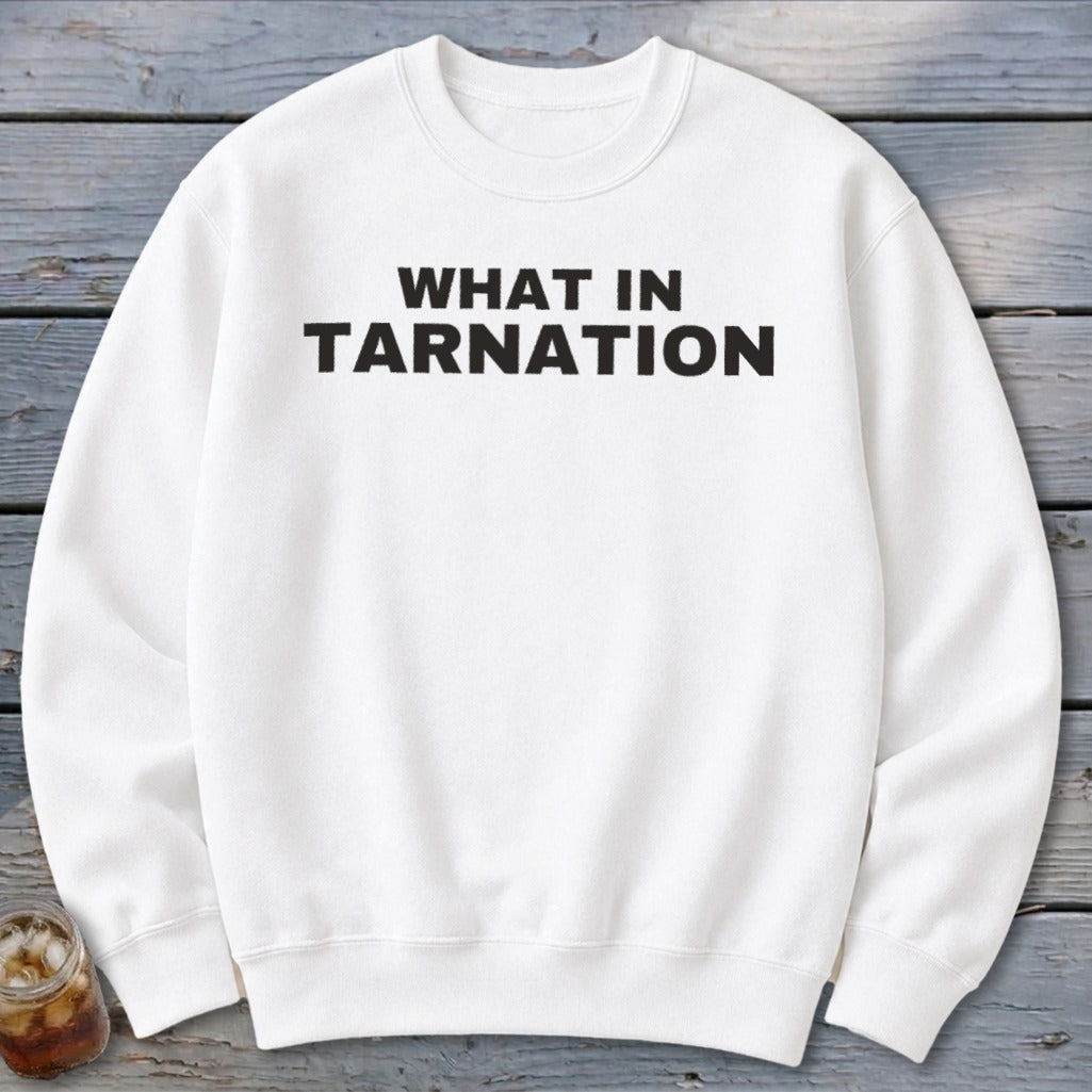 White sweatshirt with "WHAT IN TARNATION" text in black block letters.