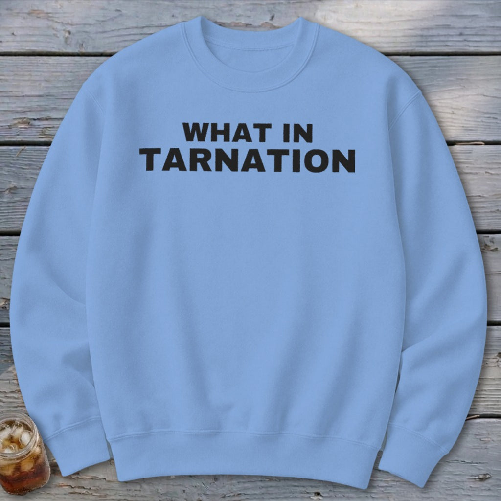 Light blue crewneck sweatshirt with black text reading "WHAT IN TARNATION".