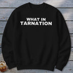 Black sweatshirt with white text reading "WHAT IN TARNATION".