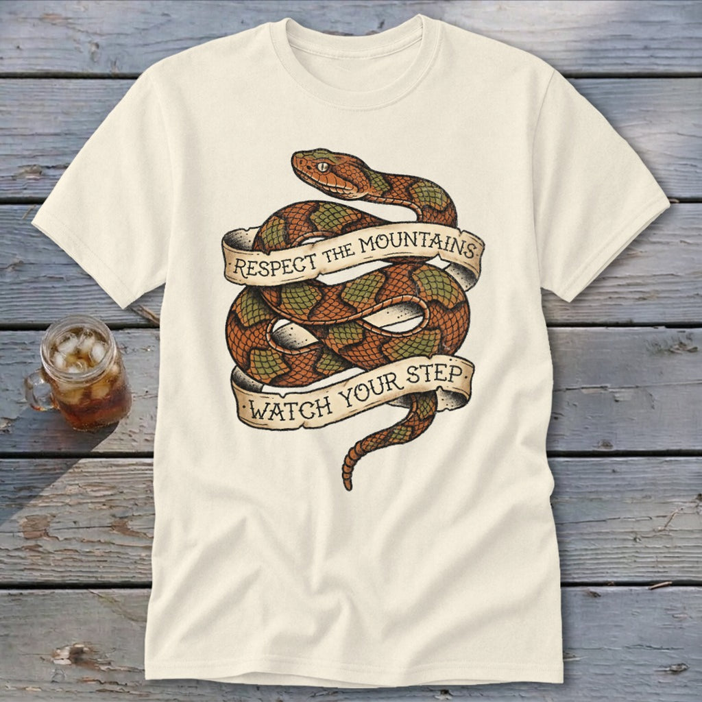 Cream t-shirt with coiled snake graphic and banner text "Respect the Mountains Watch Your Step."
