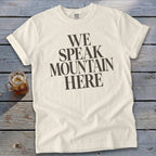 Cream t-shirt with bold black text that reads "WE SPEAK MOUNTAIN HERE".