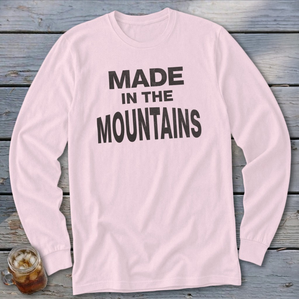 Pink long-sleeve shirt with black text reading "MADE IN THE MOUNTAINS".