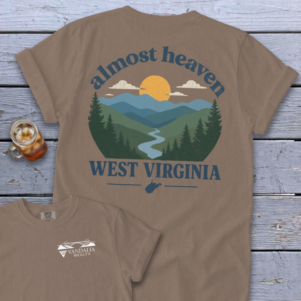 Tan t-shirt with "Almost Heaven West Virginia" text and mountain landscape graphic.