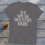 Grey t-shirt with cream text "WE SPEAK MOUNTAIN HERE".