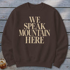 Brown crewneck sweatshirt with "WE SPEAK MOUNTAIN HERE" text.
