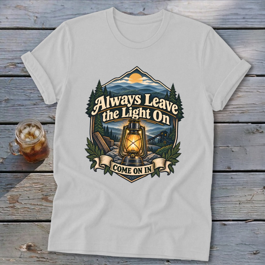 T-shirt with "Always Leave the Light On, Come on In" text and lantern graphic.