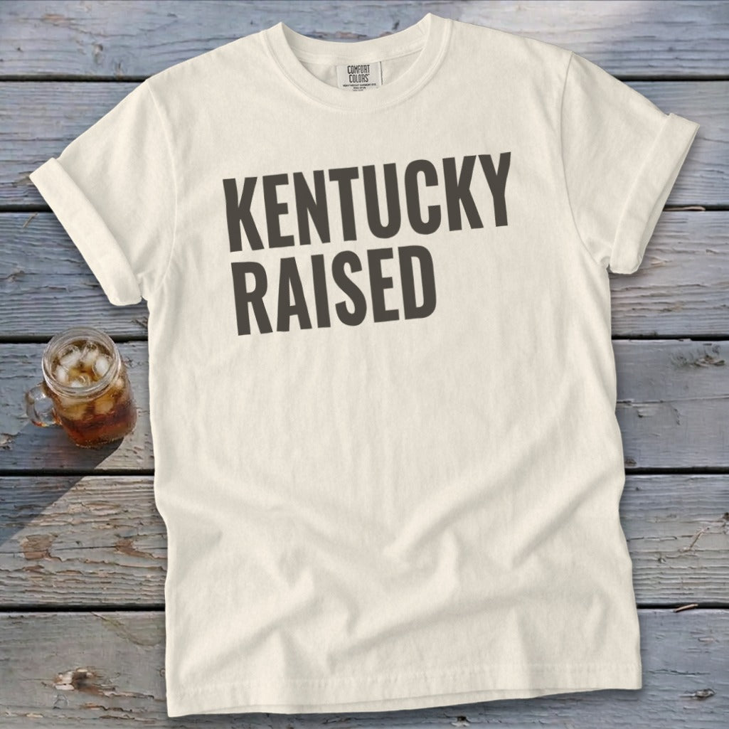 Cream t-shirt with dark gray text reading "KENTUCKY RAISED"