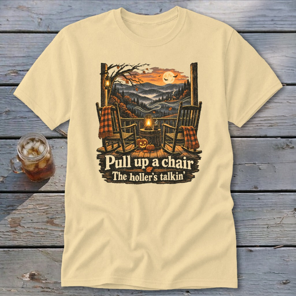 T-shirt graphic with rocking chairs on a porch overlooking a fall mountain landscape and text.