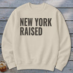 Cream sweatshirt with "NEW YORK RAISED" text in dark grey.