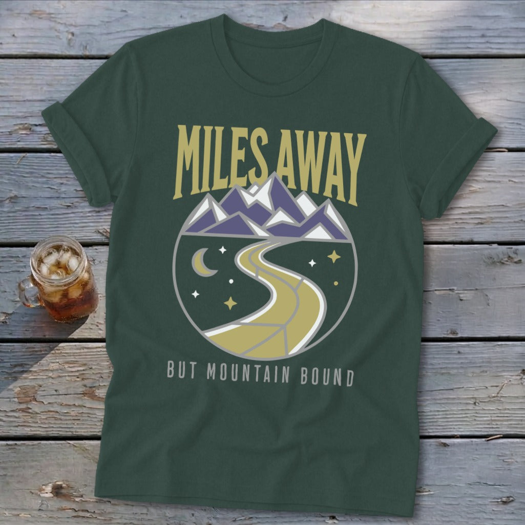 Green t-shirt with "Miles Away But Mountain Bound" text and circular mountain graphic.