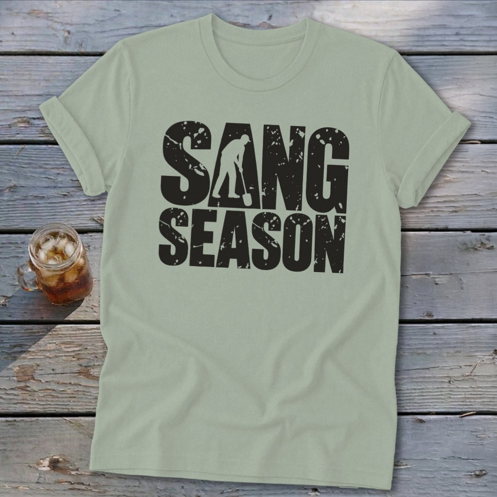 Sage green crewneck t-shirt featuring the distressed black text SANG SEASON and a silhouette of a person digging with a shovel.