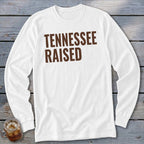 White long-sleeve shirt with brown text reading "TENNESSEE RAISED."
