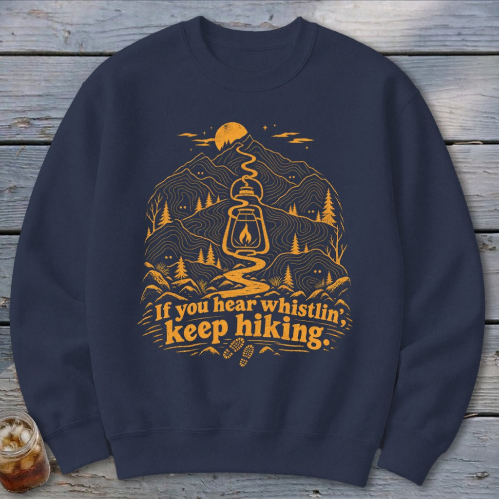 Navy sweatshirt with orange hiking graphic and text reading "If you hear whistlin', keep hiking."
