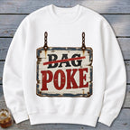 A white crewneck sweatshirt featuring a graphic of a hanging, weathered wooden sign with the text BAG POKE.