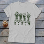Light gray crewneck t-shirt featuring a green botanical illustration of four mason jars filled with wildflowers on a shelf.