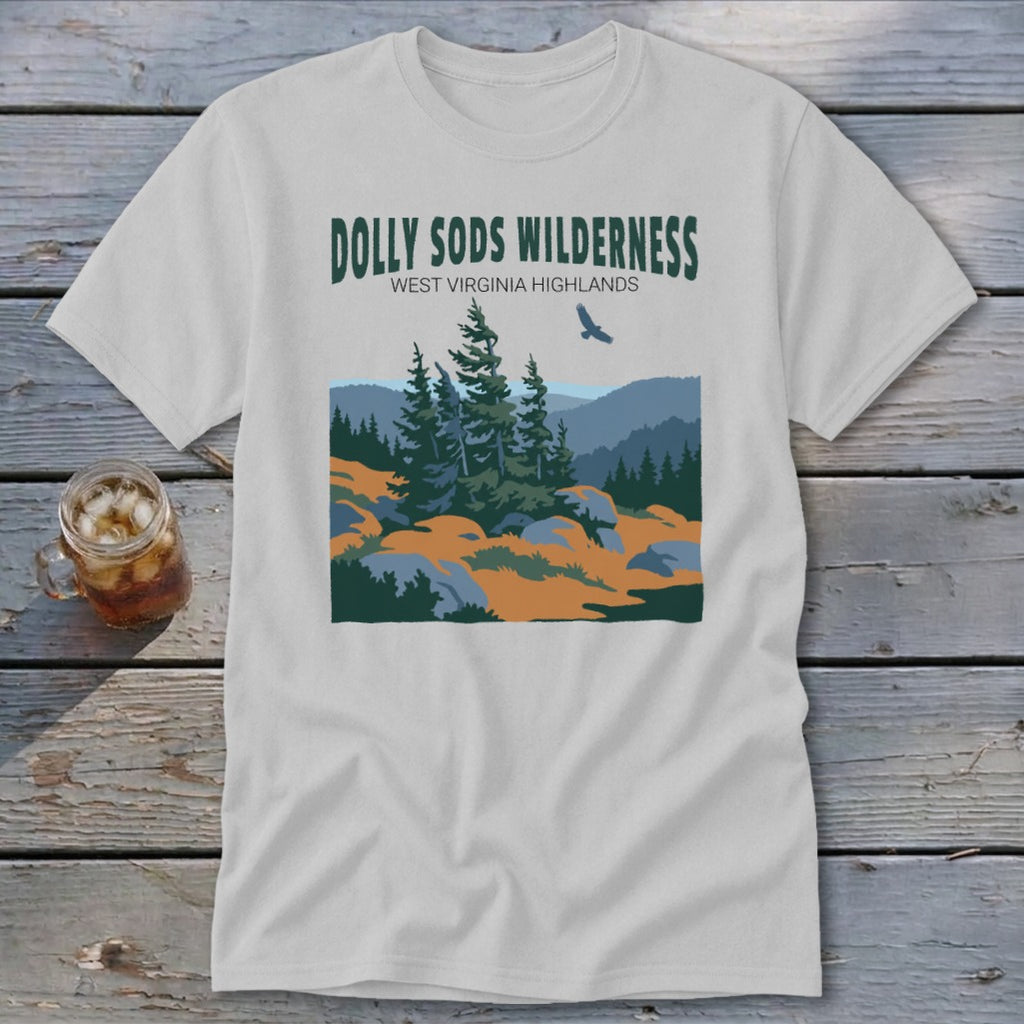 A light gray t-shirt featuring a green graphic of Dolly Sods Wilderness with everines and a flying bird.