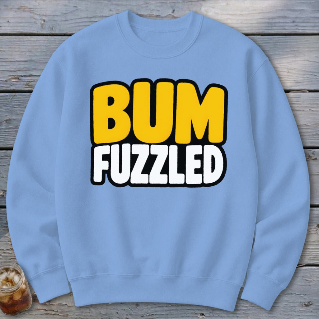 Light blue crewneck sweatshirt featuring the text BUM FUZZLED in bold yellow and white letters.
