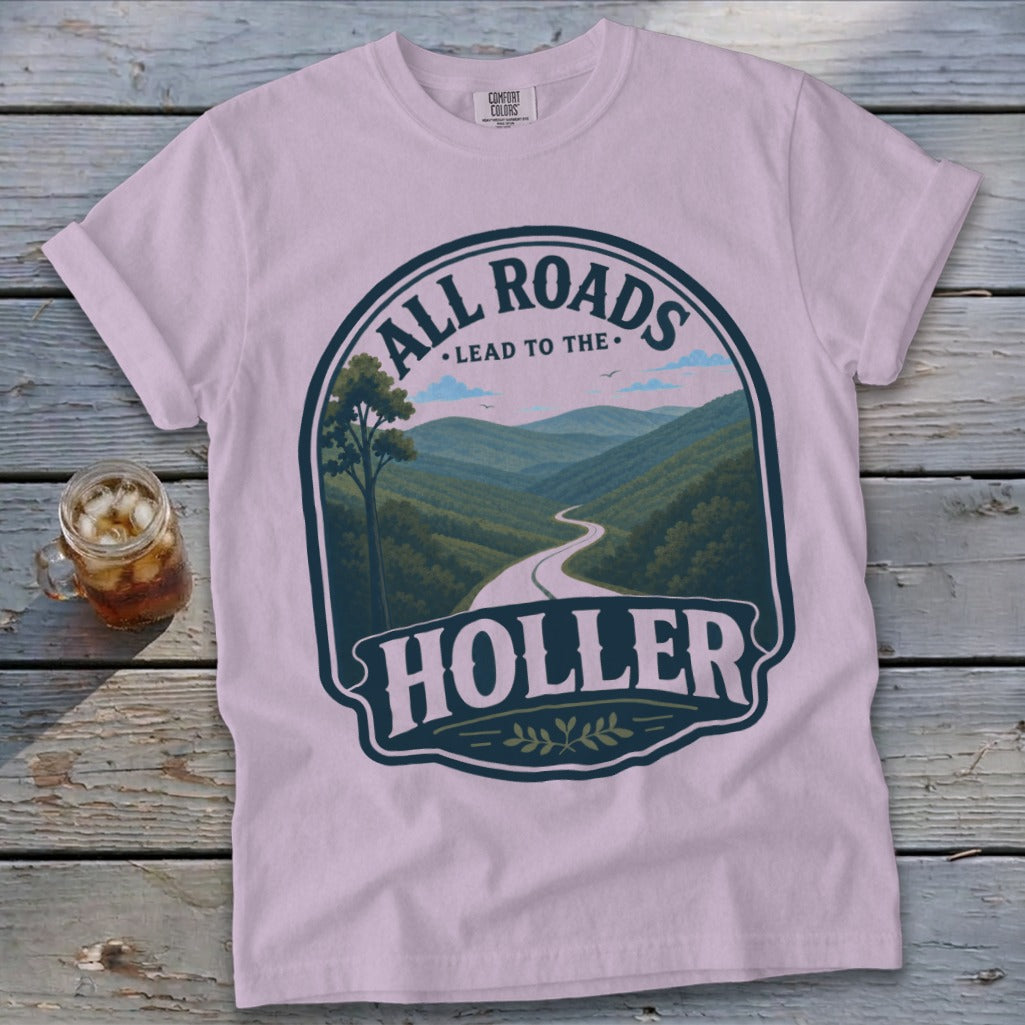 Pink t-shirt with "All Roads Lead to the Holler" text and mountain road graphic.