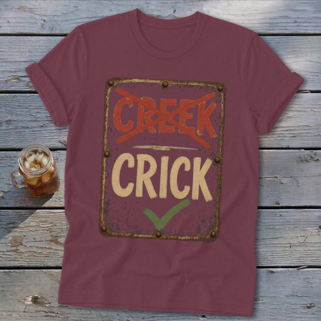 Maroon t-shirt with "CREEK" crossed out and "CRICK" checked off.