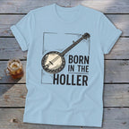 Light blue t-shirt with banjo graphic and text "BORN IN THE HOLLER".