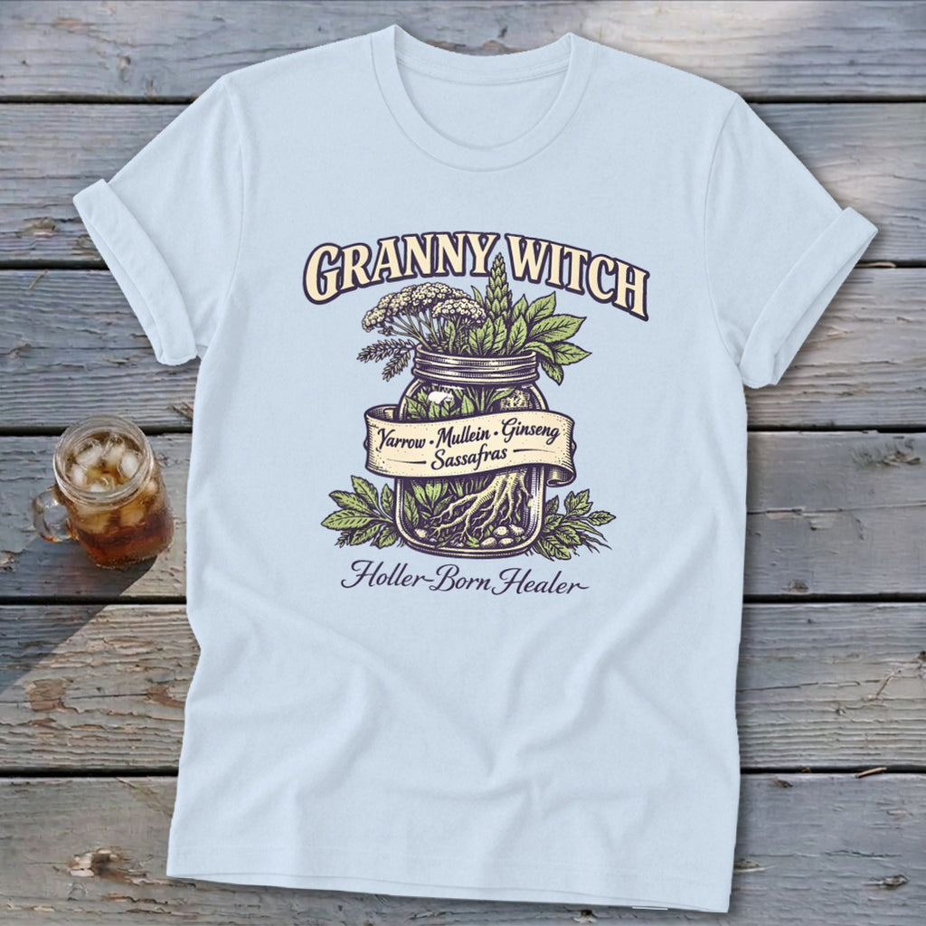 Light blue t-shirt with "Granny Witch Holler-Born Healer" text and herb-filled mason jar graphic.