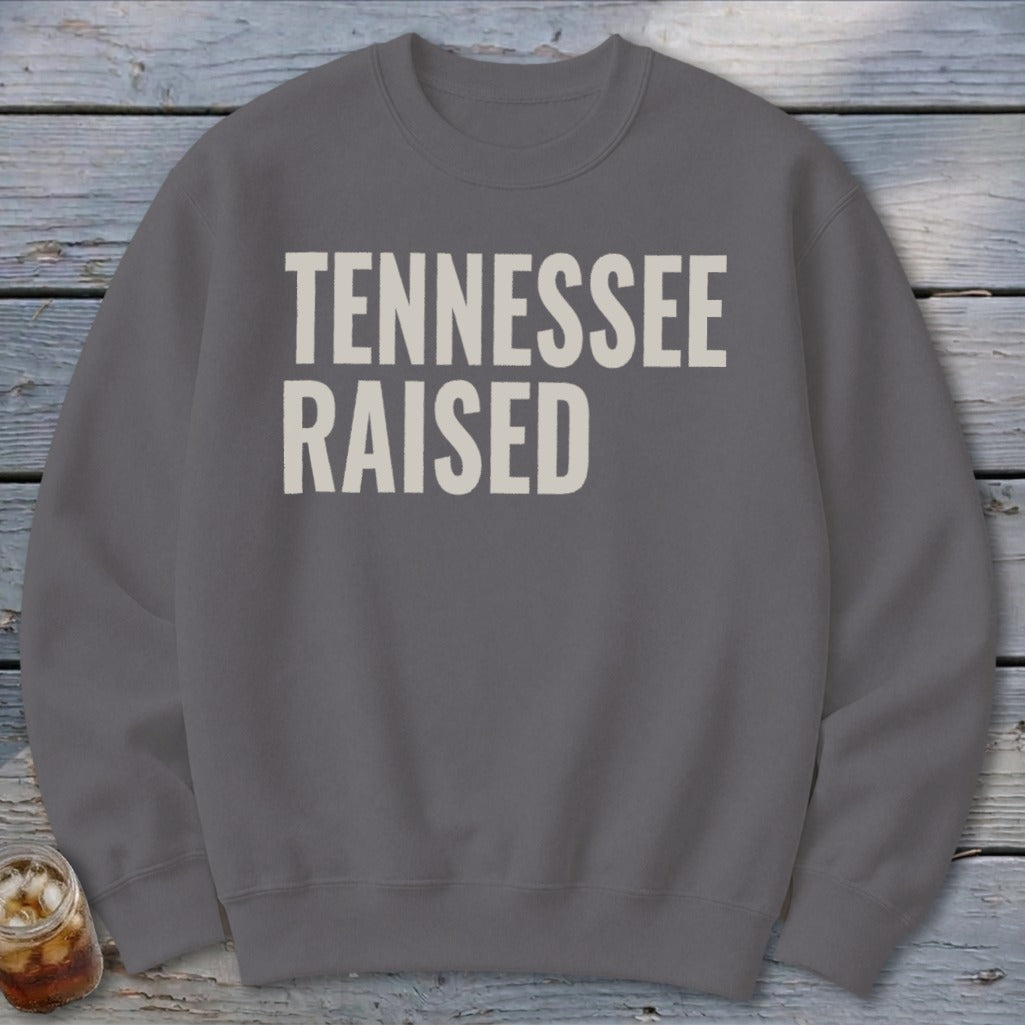 Grey crewneck sweatshirt with "TENNESSEE RAISED" text in off-white.