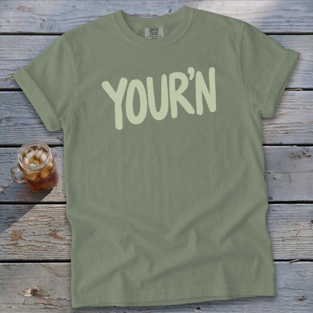Olive green Comfort Colors t-shirt with light green "YOUR'N" text and iced drink.