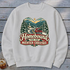 White sweatshirt with vintage "Homebound for the Mountain Christmas" graphic.
