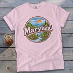 Pink t-shirt with circular Maryland landscape graphic featuring a deer and river.