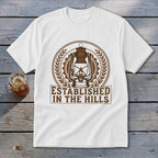 White t-shirt with a brown lantern and "ESTABLISHED IN THE HILLS" text.