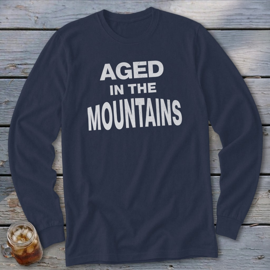 Navy long sleeve shirt with white text "AGED IN THE MOUNTAINS".