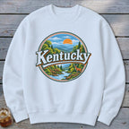 White sweatshirt with a circular "Kentucky" graphic featuring a deer and scenic mountains.