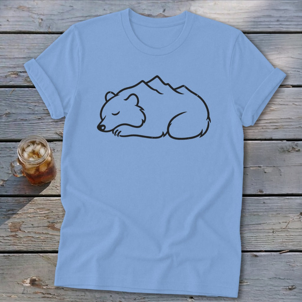 Light blue t-shirt with black outline of a sleeping bear with mountains on its back.