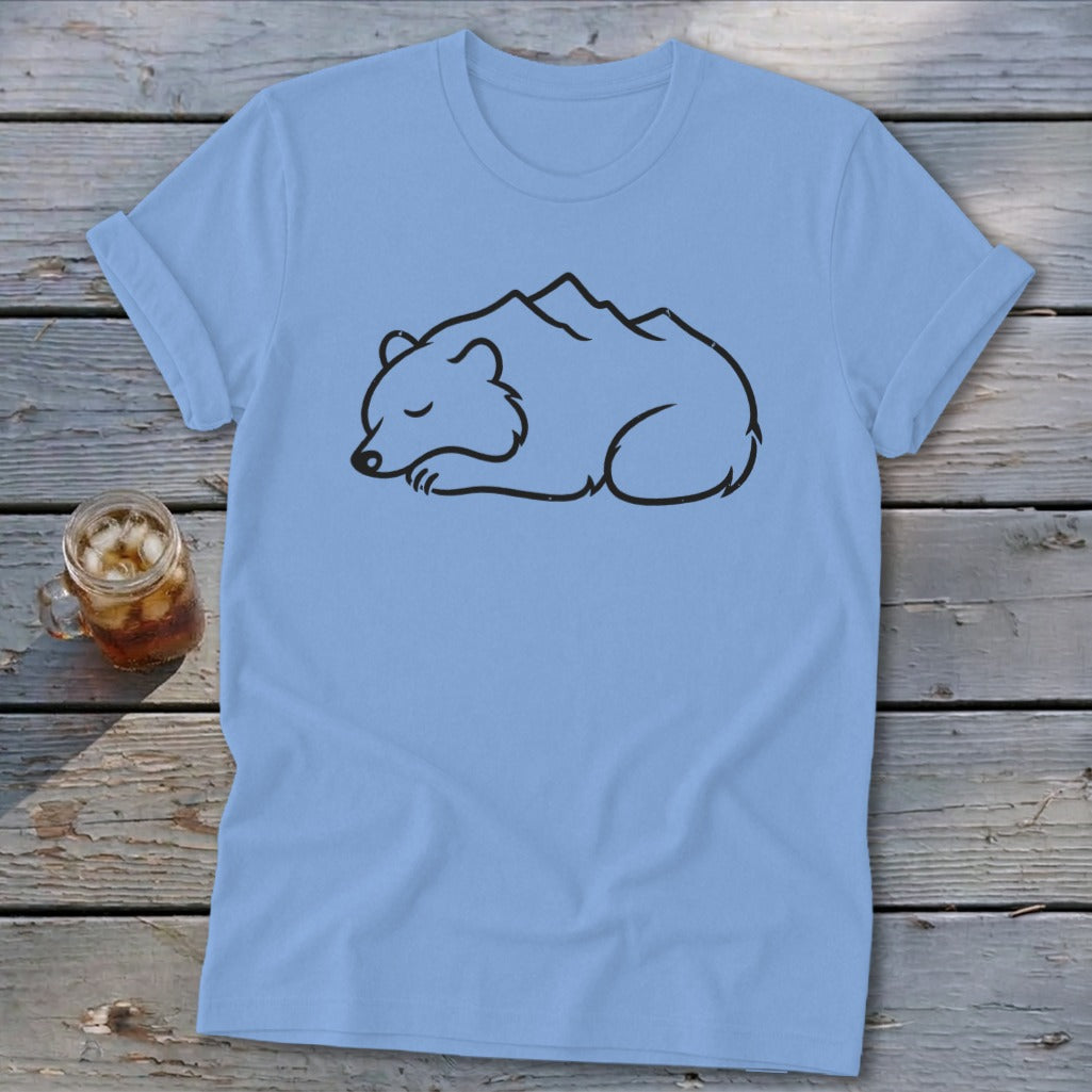 Light blue t-shirt with black outline of a sleeping bear with mountains on its back.